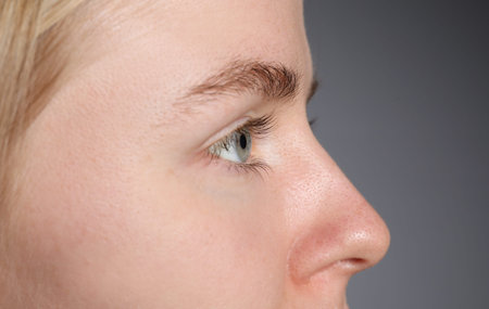 Woman with beautiful eyes on light gray background, closeupのeditorial素材