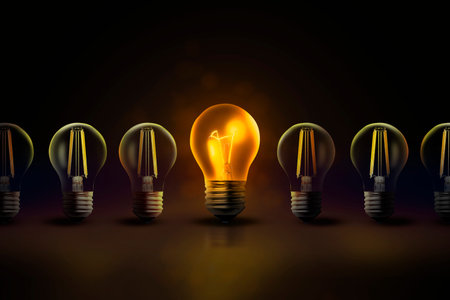 Concept of idea. One glowing light bulb among others in darkness