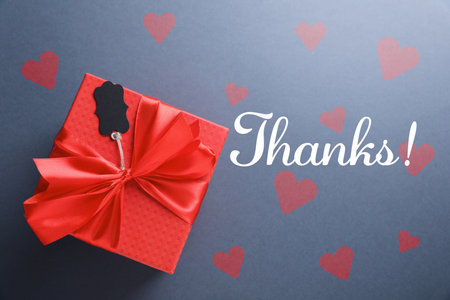 Thank you card design with gift box and red hearts on gray backgroundの写真素材