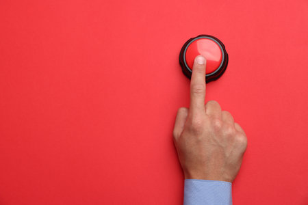 Man pressing button on red background, top view. Space for text