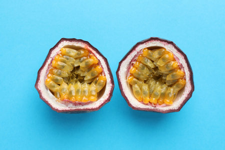 Halves of fresh passion fruit on light blue background, closeupの写真素材