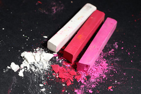 Colorful chalk pastels on black background, closeup