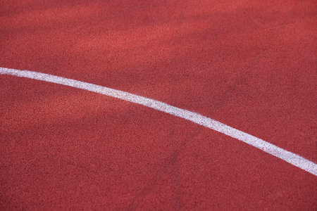Red running track with markings, above view