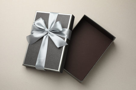 Open gift box with beautiful lid on light gray background, top viewの写真素材