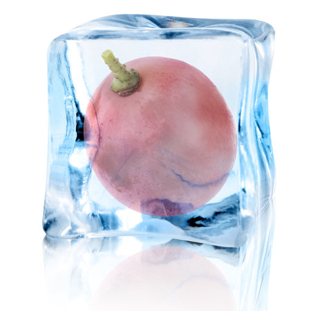 Fresh grape inside ice cube on white backgroundの写真素材