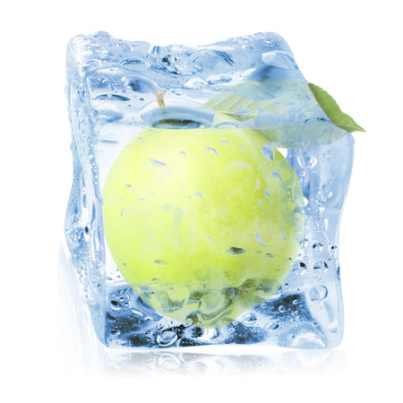 Fresh green apple inside ice cube isolated on whiteの写真素材