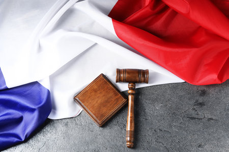 Judge's gavel and flag of France on gray table, top viewの写真素材