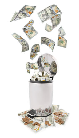 Money falling into trash bin against white backgroundの写真素材