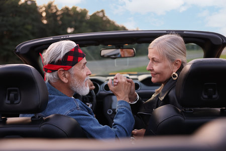 Stylish senior couple in modern cabriolet outdoorsの写真素材