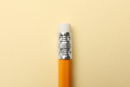 One graphite pencil on beige background, top viewの写真素材