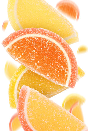 Sweet jelly candies falling against white background