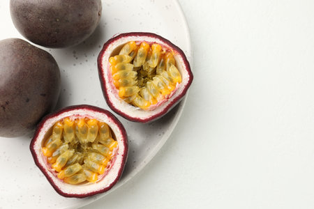 Fresh passion fruits on white table. Space for text
