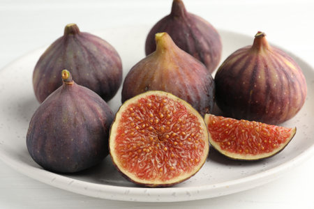 Whole and cut figs on light table, closeup