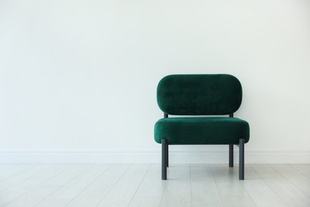 Stylish armchair near white wall in room, space for textの写真素材