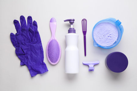 Hair care product for blonde hair and hairdresser's tools on white background, flat layの写真素材