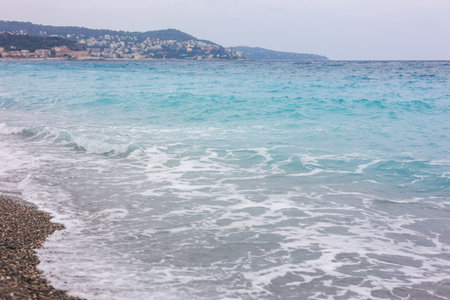 Beautiful view of wavy sea and pebbles on beach