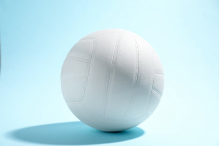 One white volleyball ball on light blue backgroundの写真素材