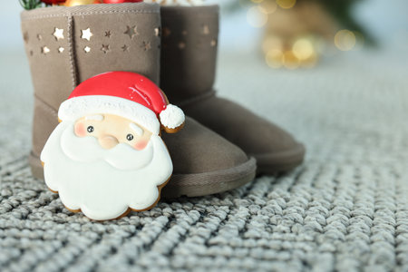 Saint Nicholas day tradition. Boots and gingerbread cookies on floor indoors, closeupの写真素材