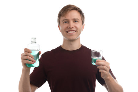 Man with mouthwash on white background. Oral hygieneの写真素材