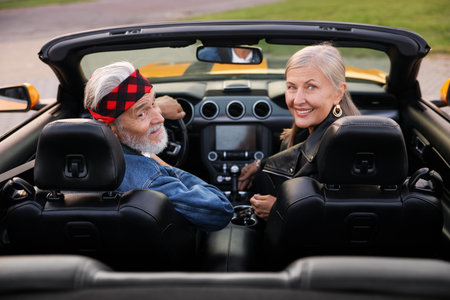 Stylish senior couple in modern cabriolet outdoorsの写真素材