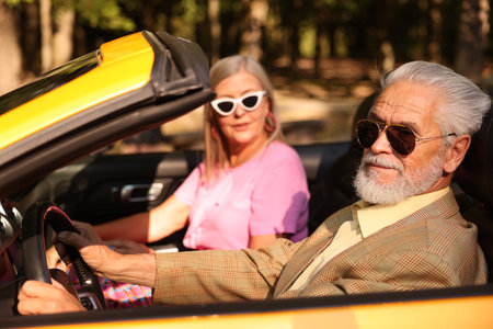Senior couple enjoying cabriolet ride, selective focusの写真素材