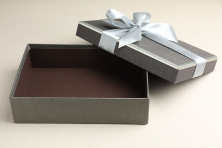 Open gift box with beautiful lid on light gray backgroundの写真素材