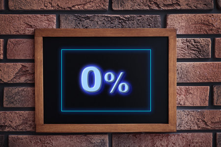 Chalkboard with 0% hanging on brick wall