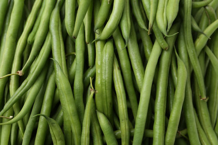 Fresh green bean pods as background, closeup