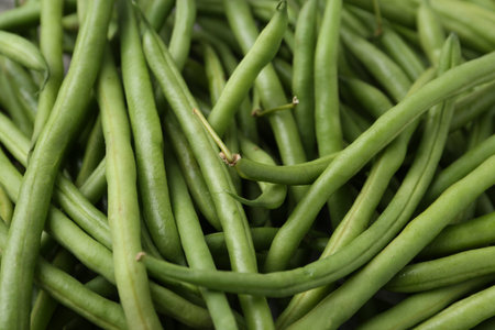 Fresh green bean pods as background, closeup