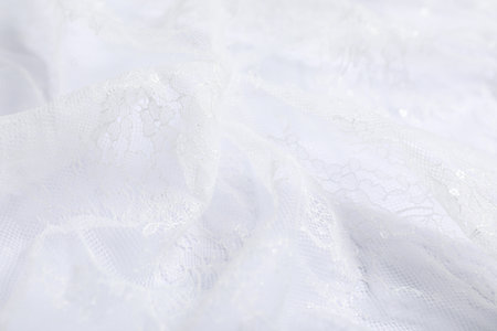 Beautiful lace fabric on white background, closeup