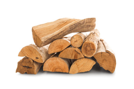 Pile of cut firewood isolated on white