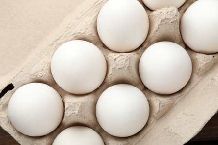 Raw chicken eggs in egg carton, top view