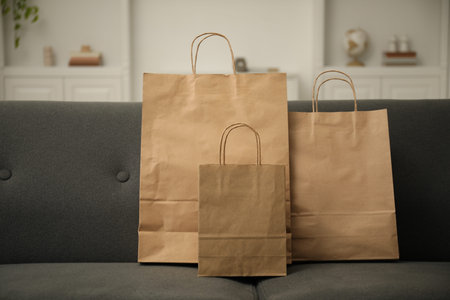 Paper shopping bags on sofa at homeの写真素材