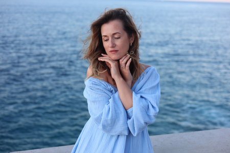 Beautiful woman near sea on summer dayの写真素材