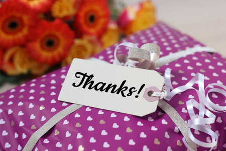 Thank tag attached to gift box, closeup