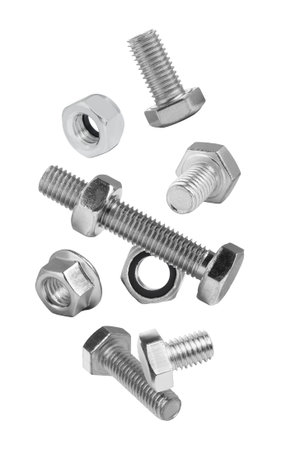 Different bolts and nuts falling against white background