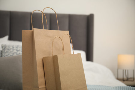 Paper bags on bed at home. Space for textの写真素材