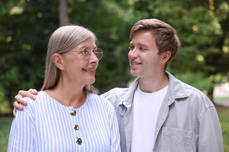 Happy mother and her sons outdoors. Family bonding