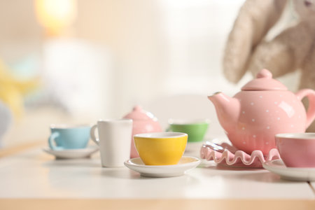 Tea set on white table indoors, closeup with space for text. Child's toyの写真素材