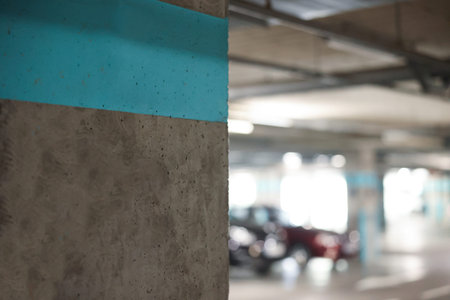 Underground parking with dedicated spots and cars, selective focus