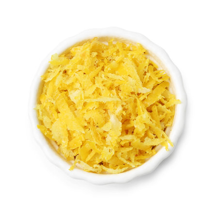 Lemon zest in bowl isolated on white, top view