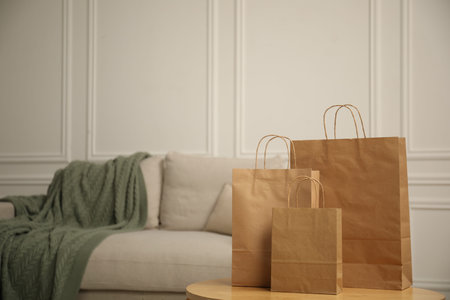Paper bags on wooden table at home. Space for textの写真素材