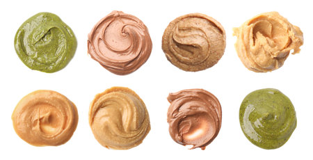 Smooth and velvety food texture. Spreads of different nuts isolated on white, set. Top view