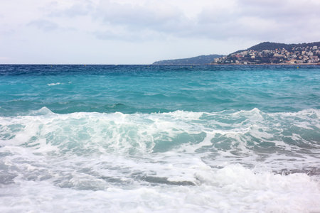 Beautiful view of wavy sea and pebbles on beach