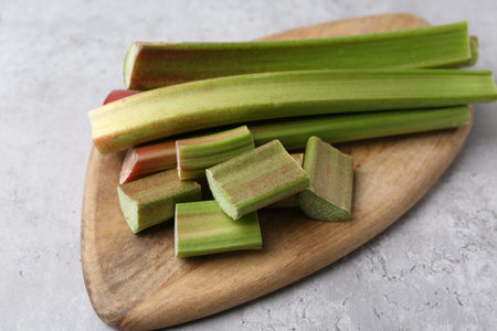 Fresh ripe rhubarb on gray table, closeup