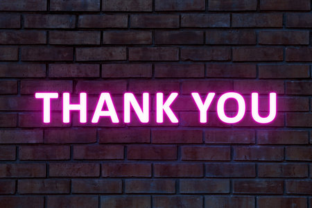 Thank you card design with glowing words on brick wallの写真素材