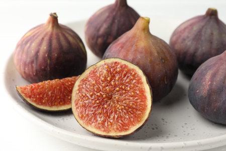 Whole and cut figs on light table, closeup