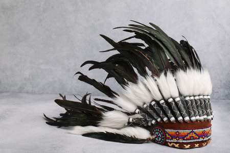 Traditional warbonnet (Native American chief headdress) on light gray table