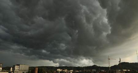 Beautiful sky with dark clouds over city in evening