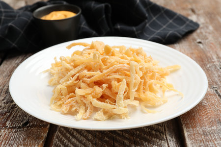 Dried squid shavings on color wooden table, closeupの写真素材